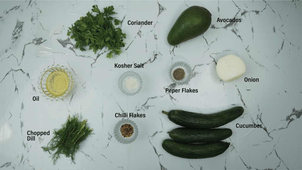 ingredients for avocado cucumber salad on a kitchen counter