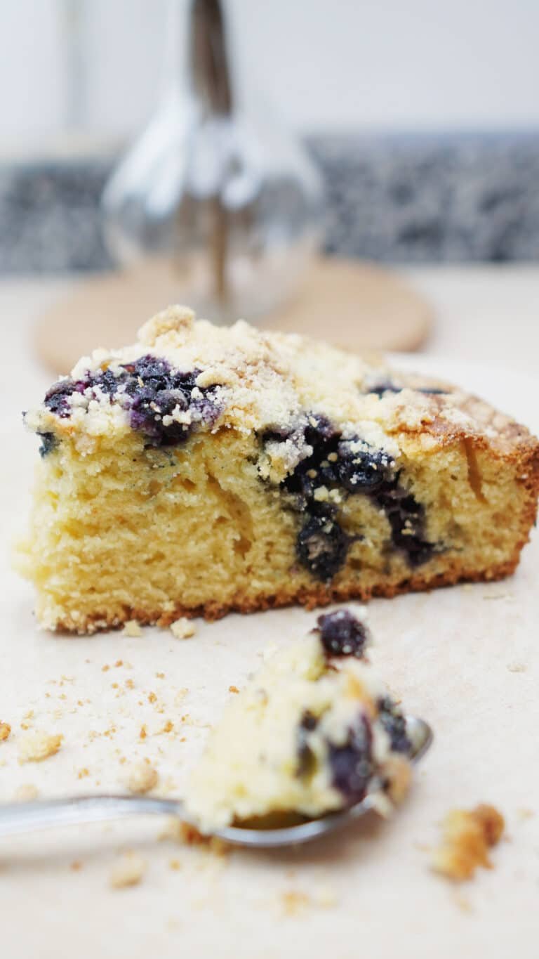 Easy blueberry cake slice with crumb topping and blueberries