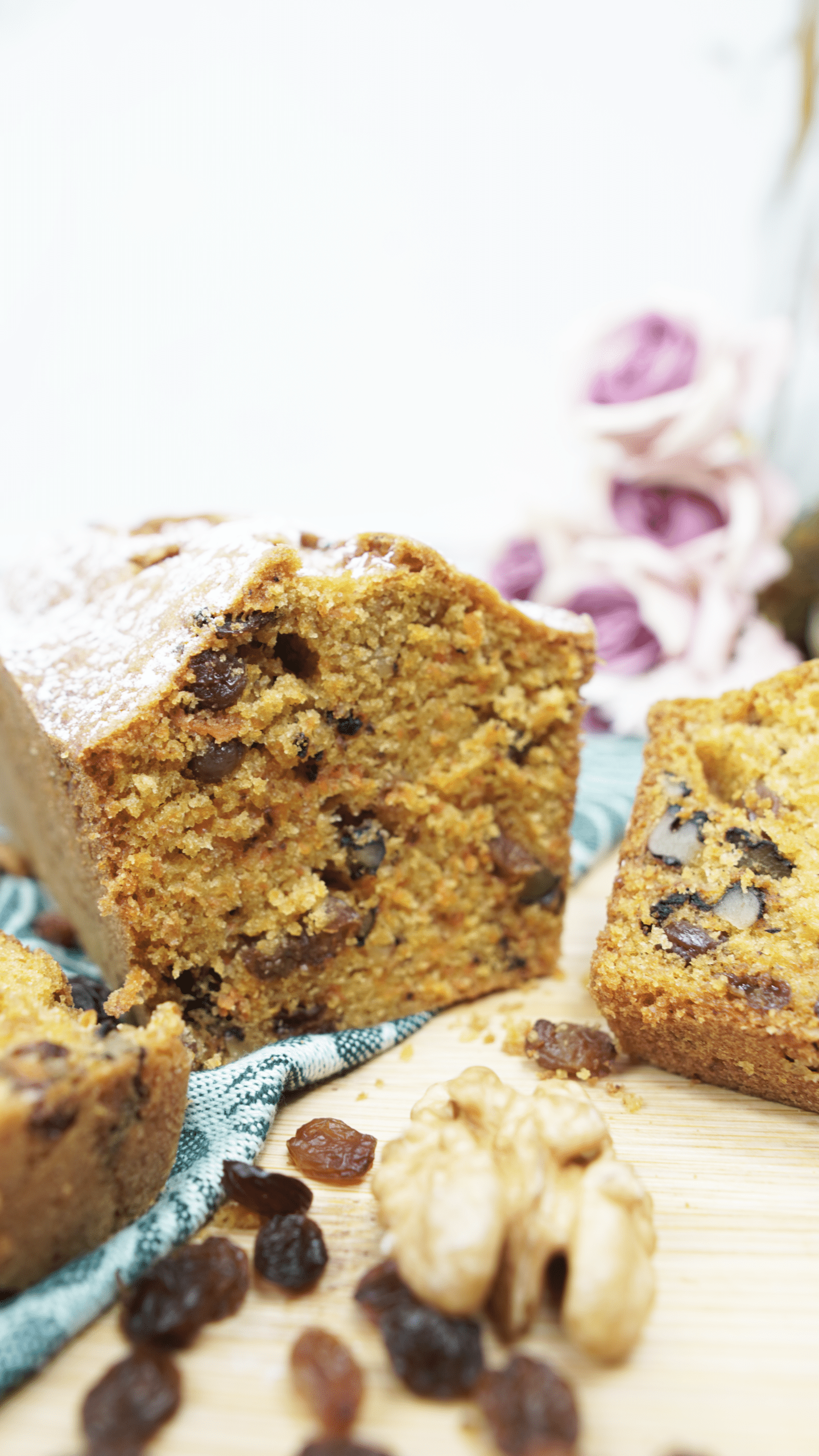 close-up of sliced carrot cake loaf with walnuts and raisins