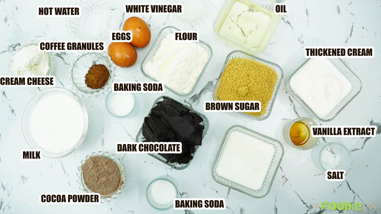 Ingredients for chocolate cupcakes with ganache frosting and cream filling (flour, cocoa, eggs, milk, cream, dark chocolate)