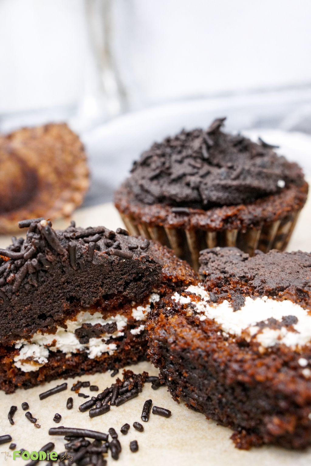 Chocolate cupcakes with creamy filling and chocolate sprinkles, close-up
