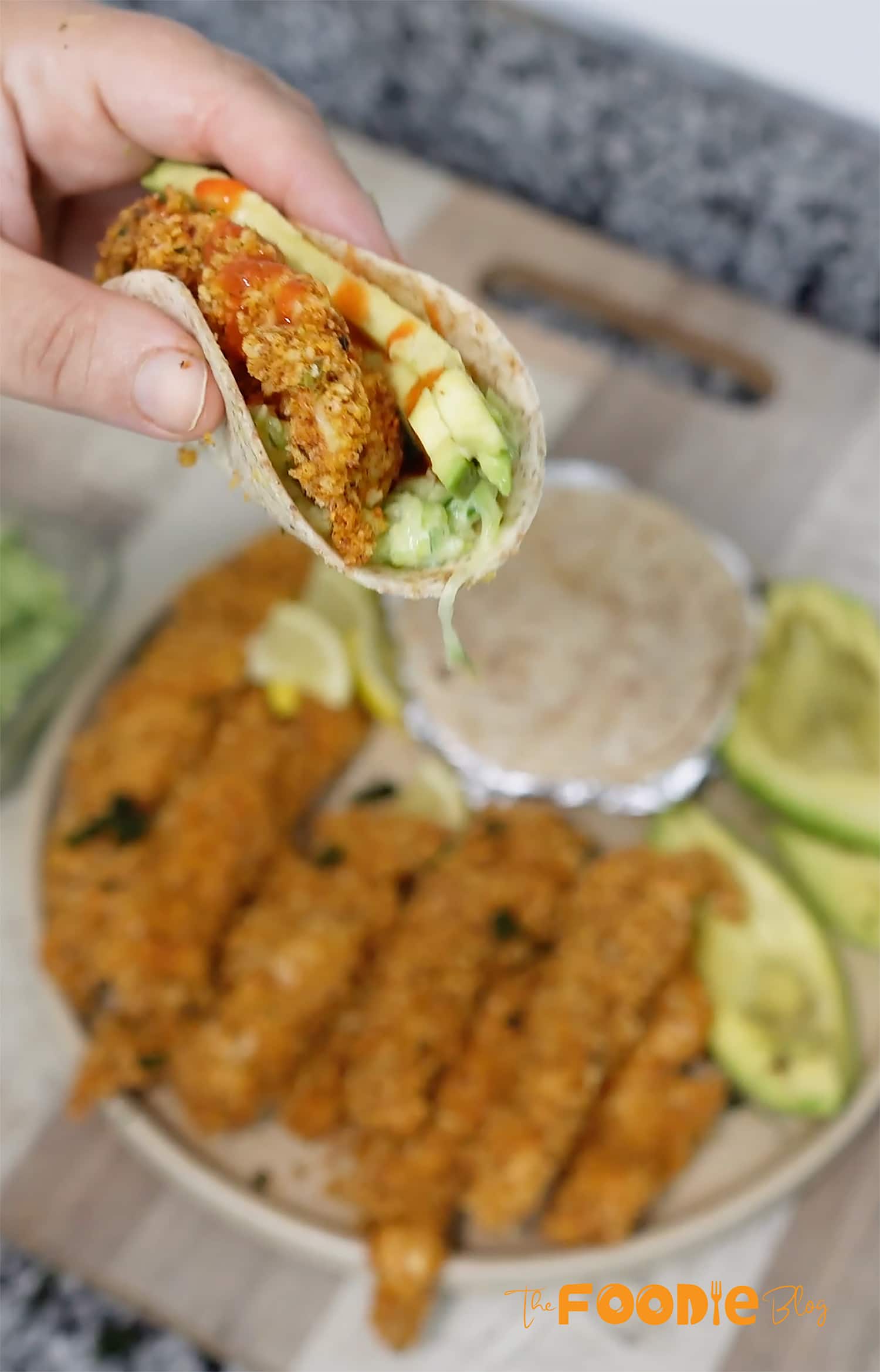 crispy baked chicken strips served with tortillas, avocado slices, and lemon wedges