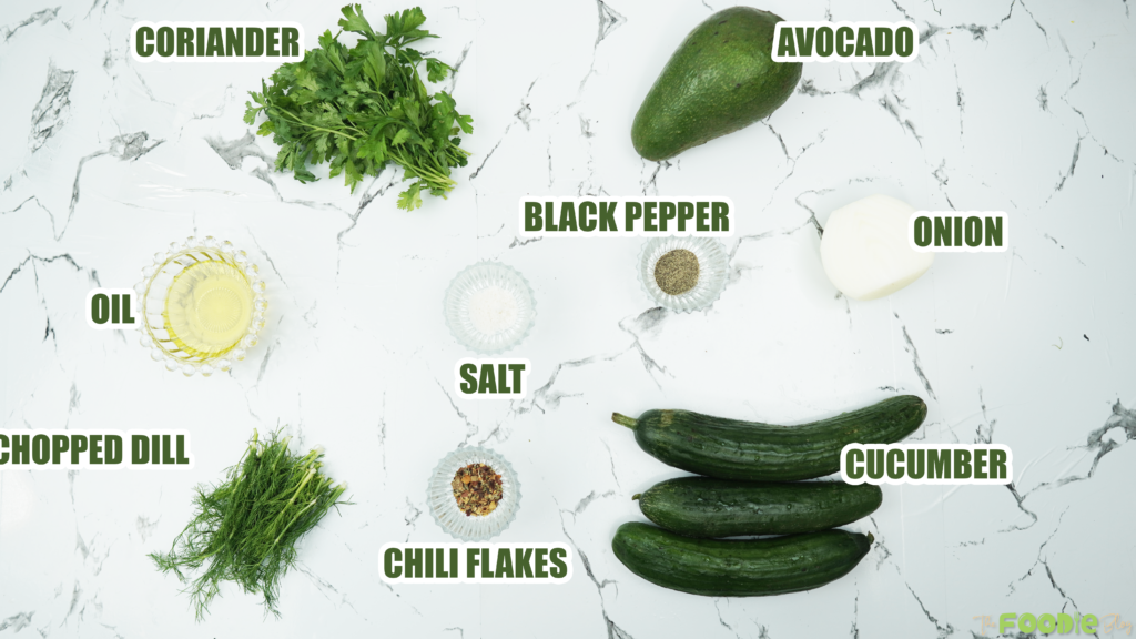 Ingredients for cucumber avocado salad including cucumbers, avocado, onion, coriander, dill, olive oil and chili flakes
