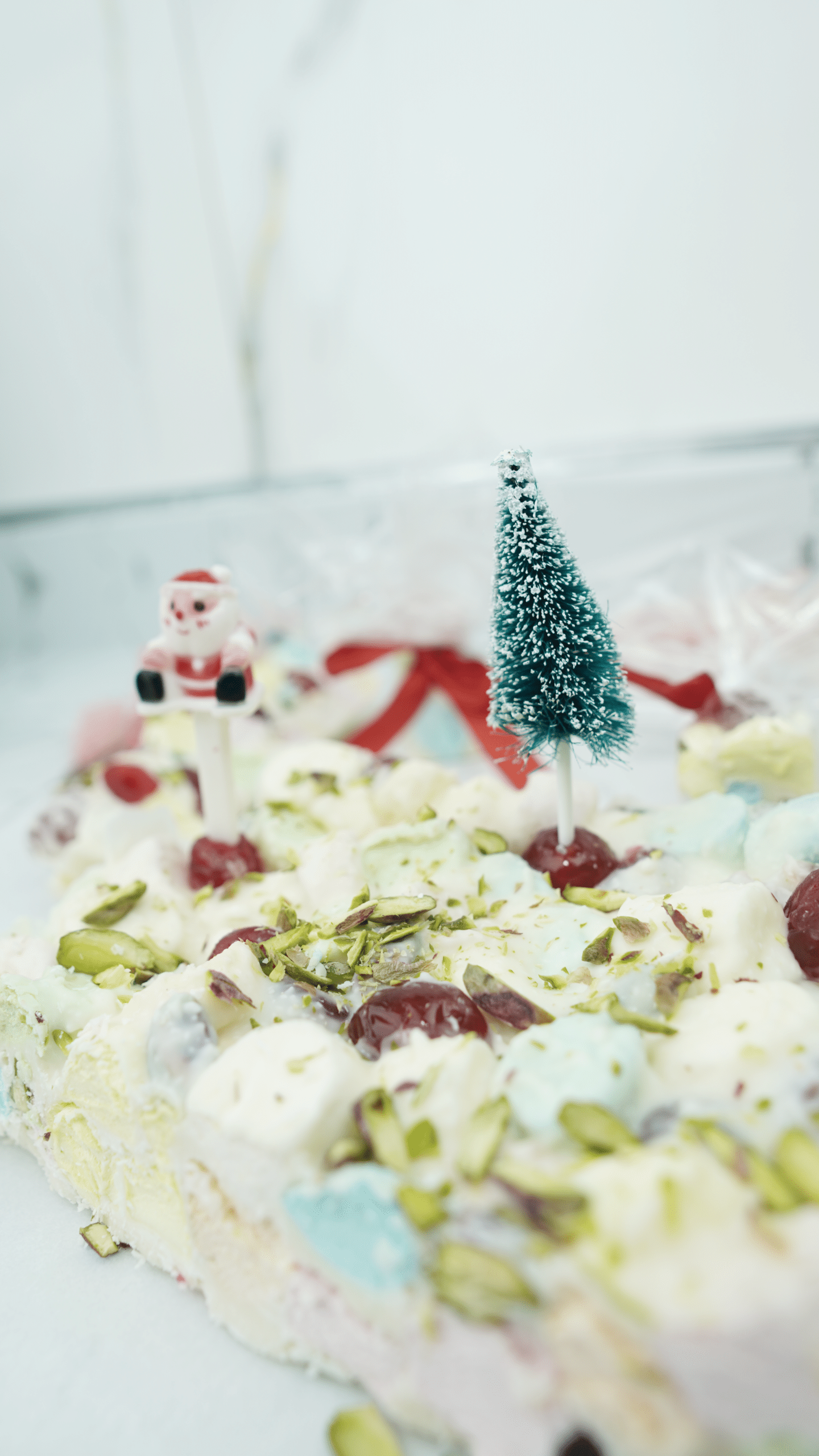 white rocky road slab decorated for christmas with cherries and pistachios