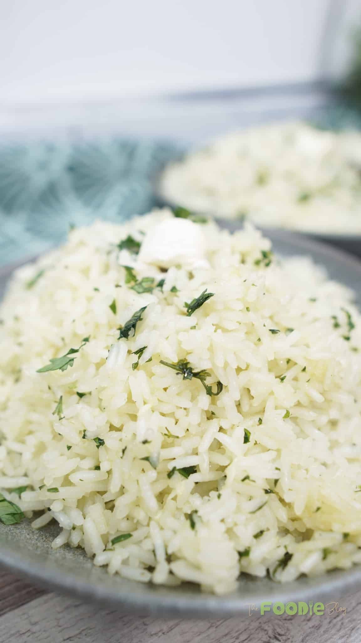 Fluffy white rice grains with chopped herbs in a bowl