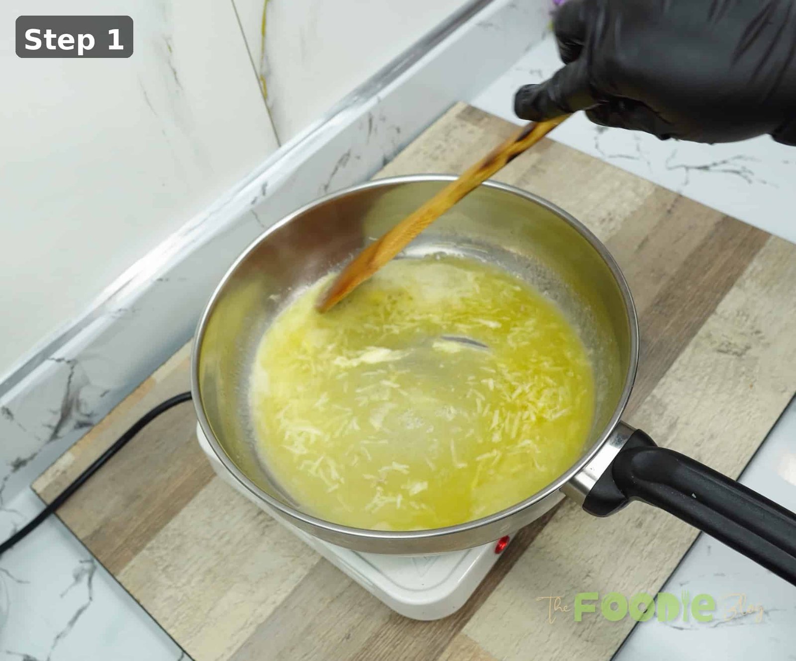 Minced garlic warming in melted butter in a saucepan