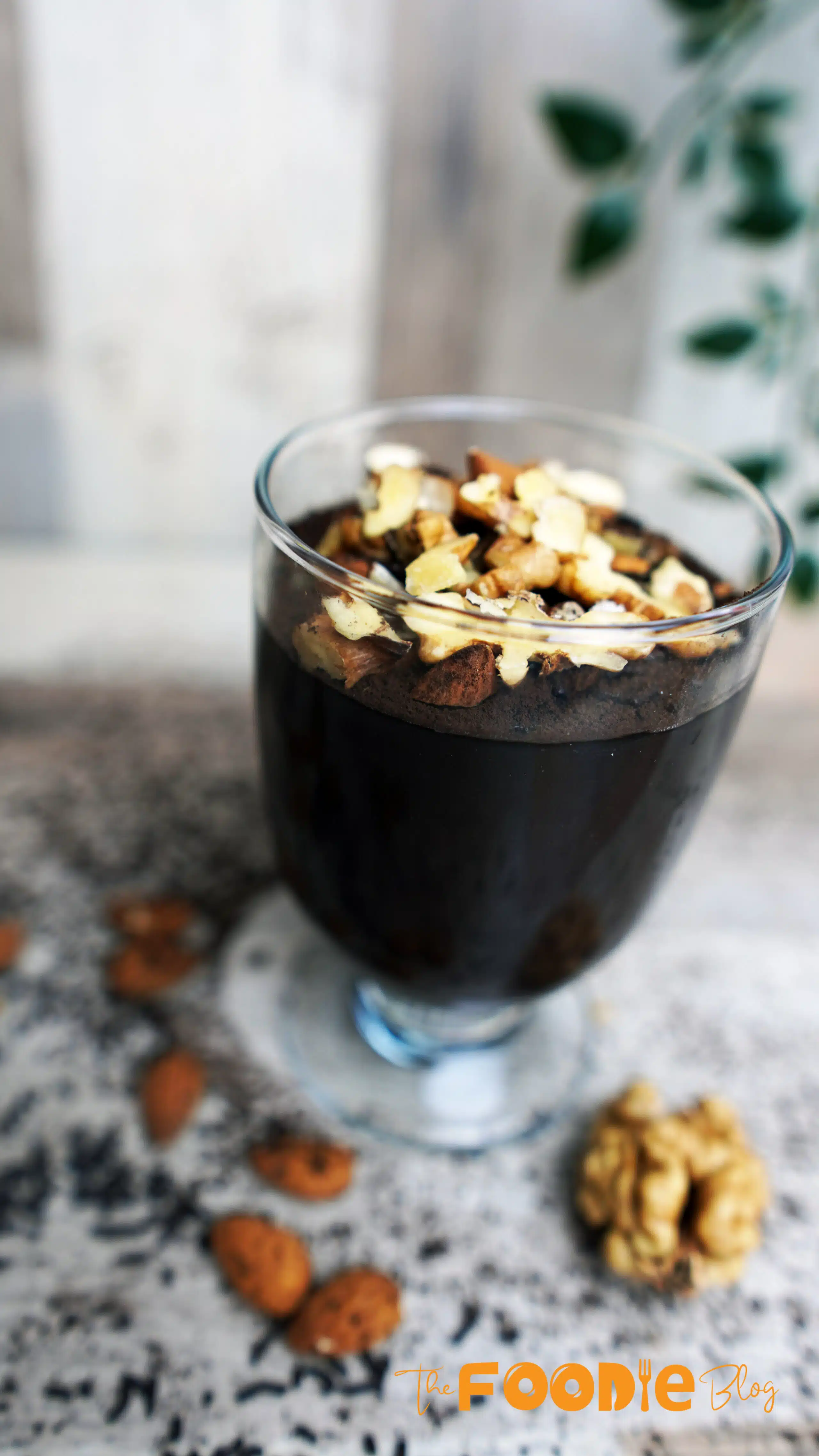 Warm chocolate pudding being poured into small glass cups.