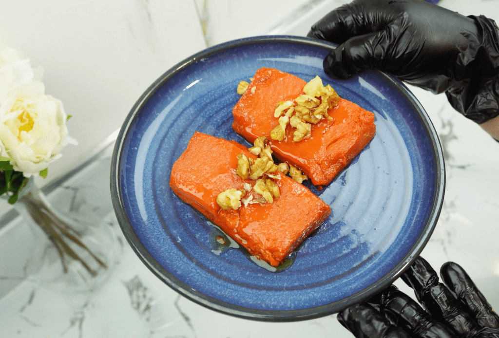 serving oven baked pumpkin dessert with walnuts