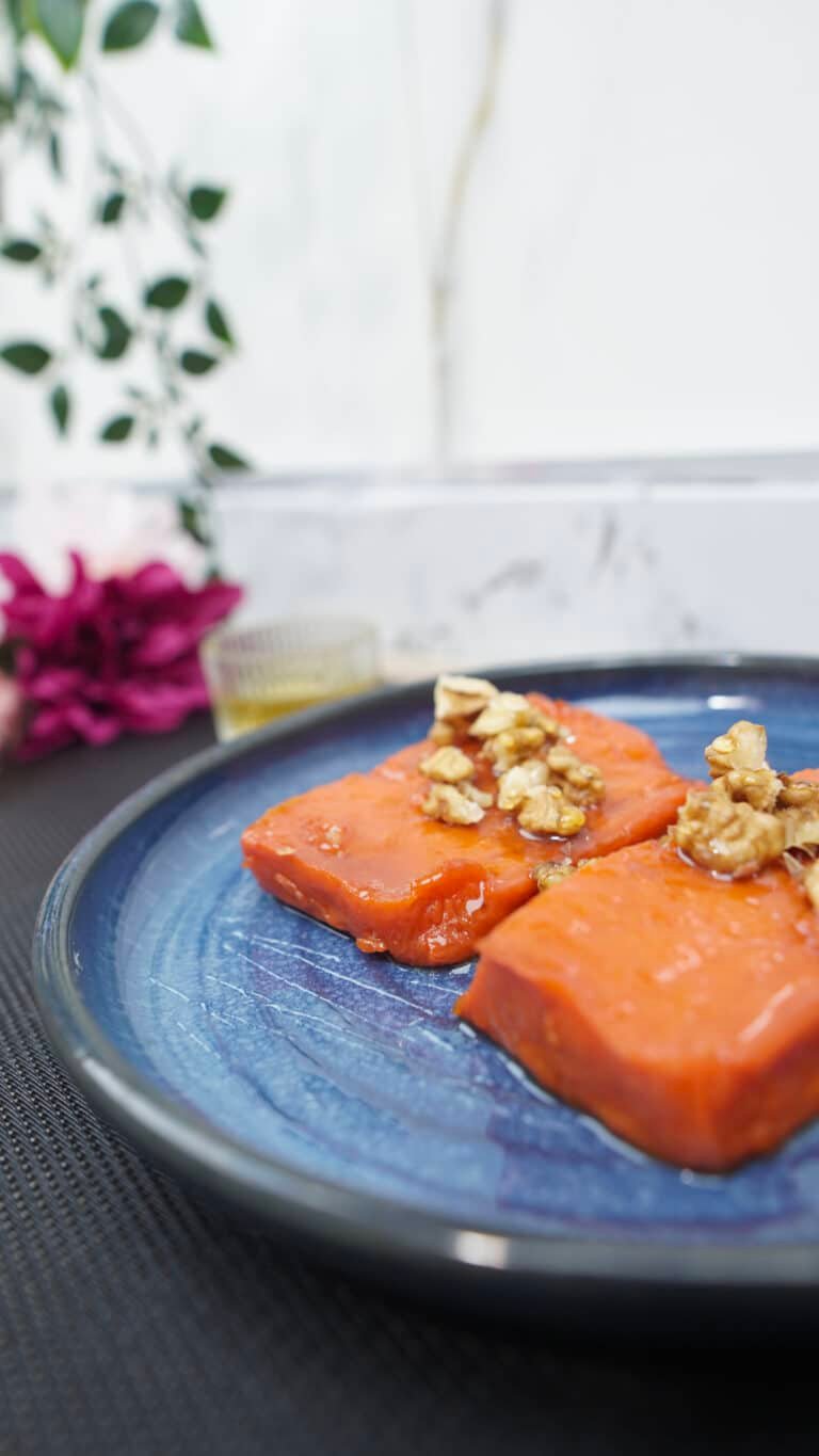 baked pumpkin dessert topped with walnuts on a plate