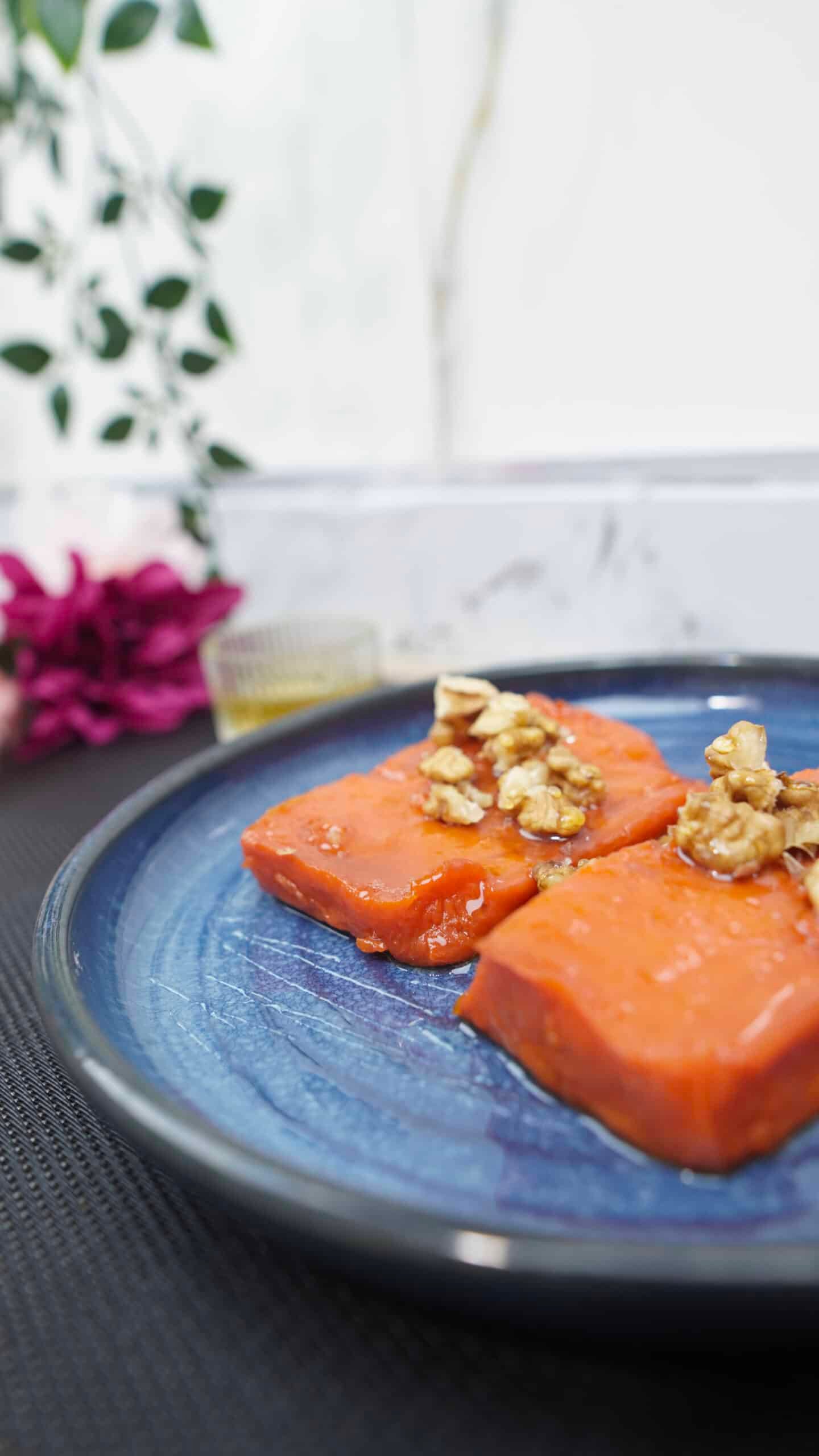 baked pumpkin dessert topped with walnuts on a plate