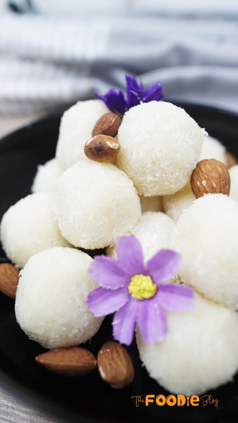 Close-up of coconut-coated balls with almonds in the bowl