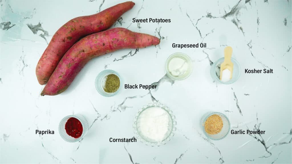 Sweet potatoes and seasonings measured out on a countertop