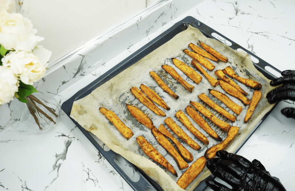 Baked sweet potato fries on a sheet pan after cooking