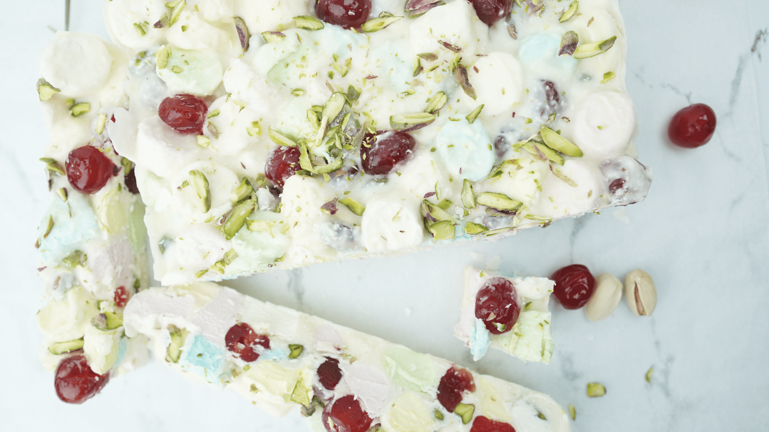 overhead view of white chocolate rocky road with marshmallows cherries and pistachios