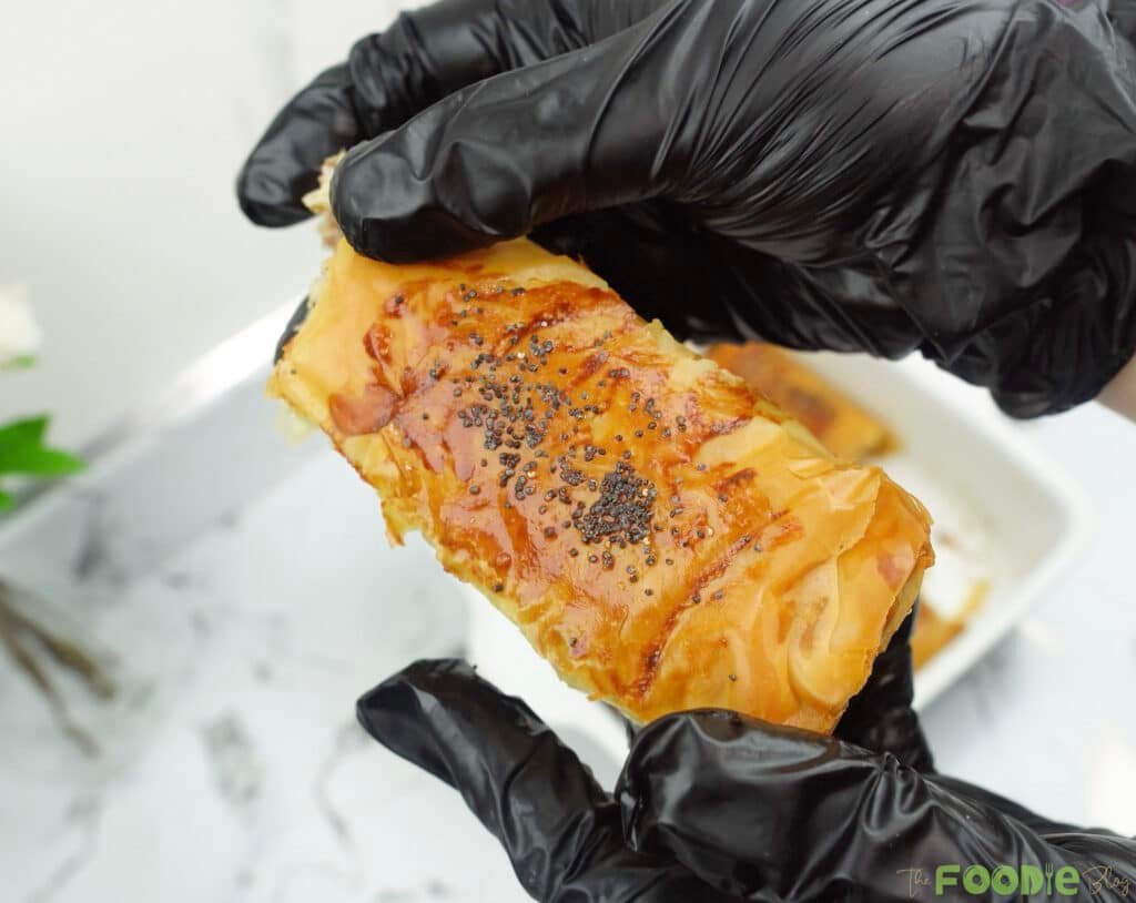 Golden crispy minced meat cigars in a baking dish