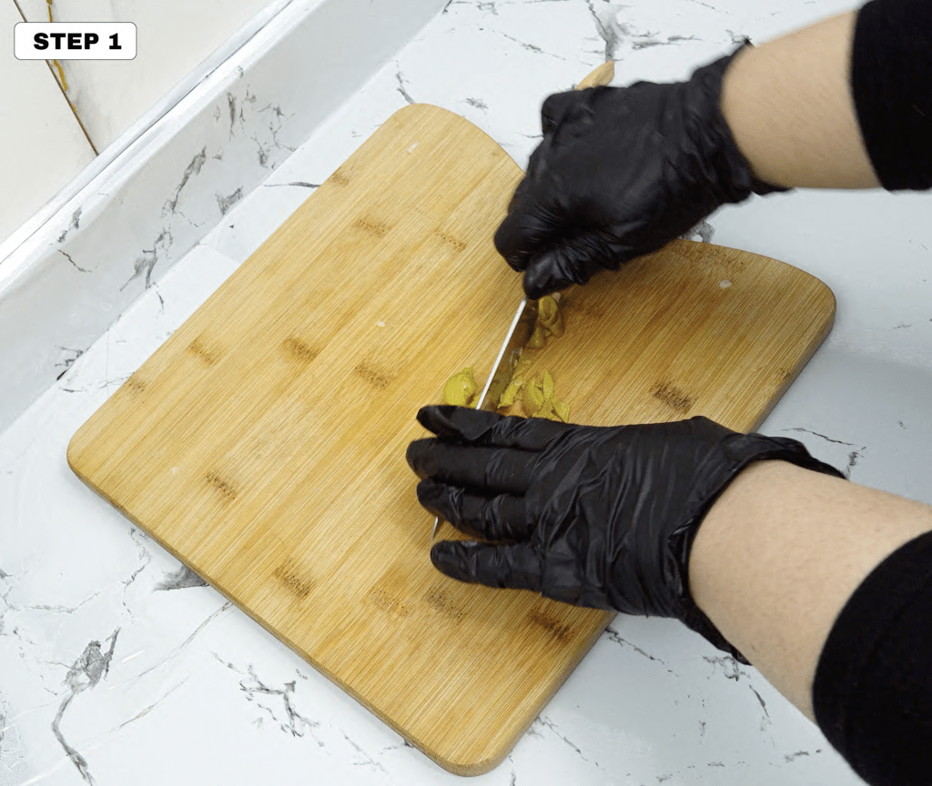 Chopping pickled pepper on a wooden cutting board