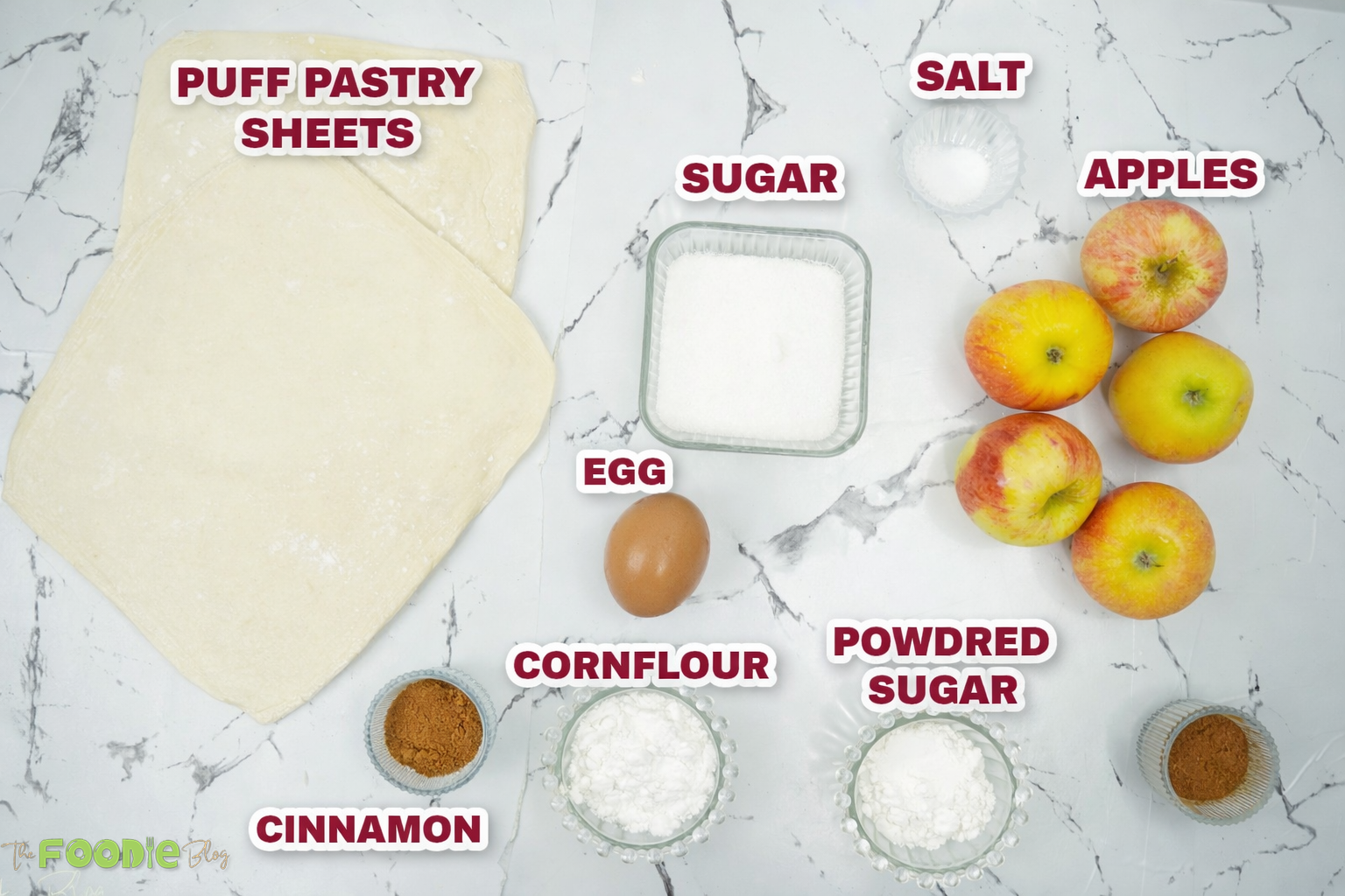 Ingredients for apple turnovers including puff pastry sheets, apples, sugar, cinnamon, cornstarch and egg