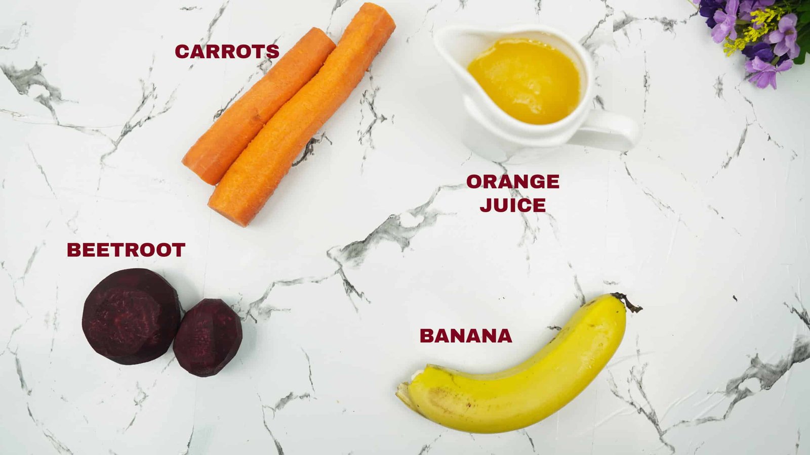 Beetroot, carrots, banana, and orange juice arranged on a light background