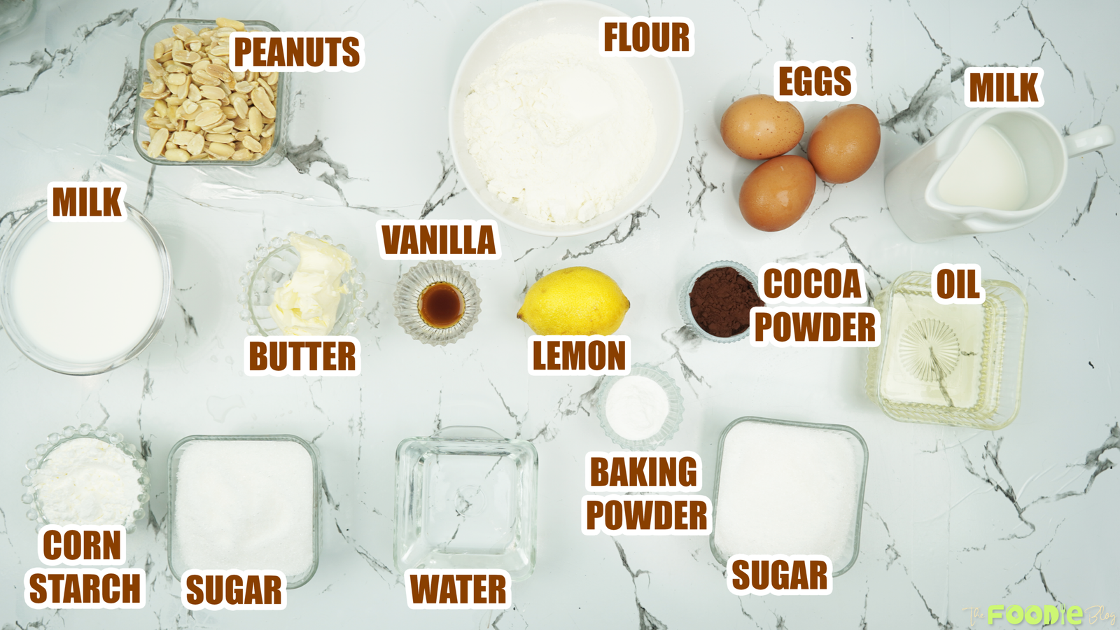 Labeled ingredients on a marble counter for caramel peanut cake and sauce
