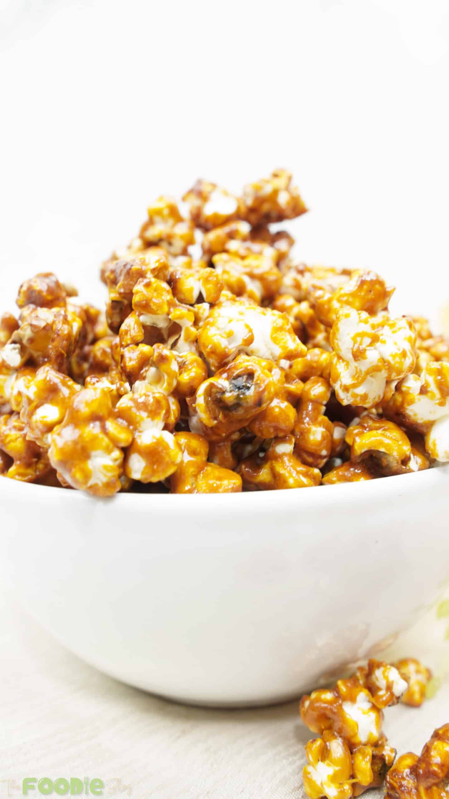 Close-up of glossy caramel-coated popcorn piled in a bowl
