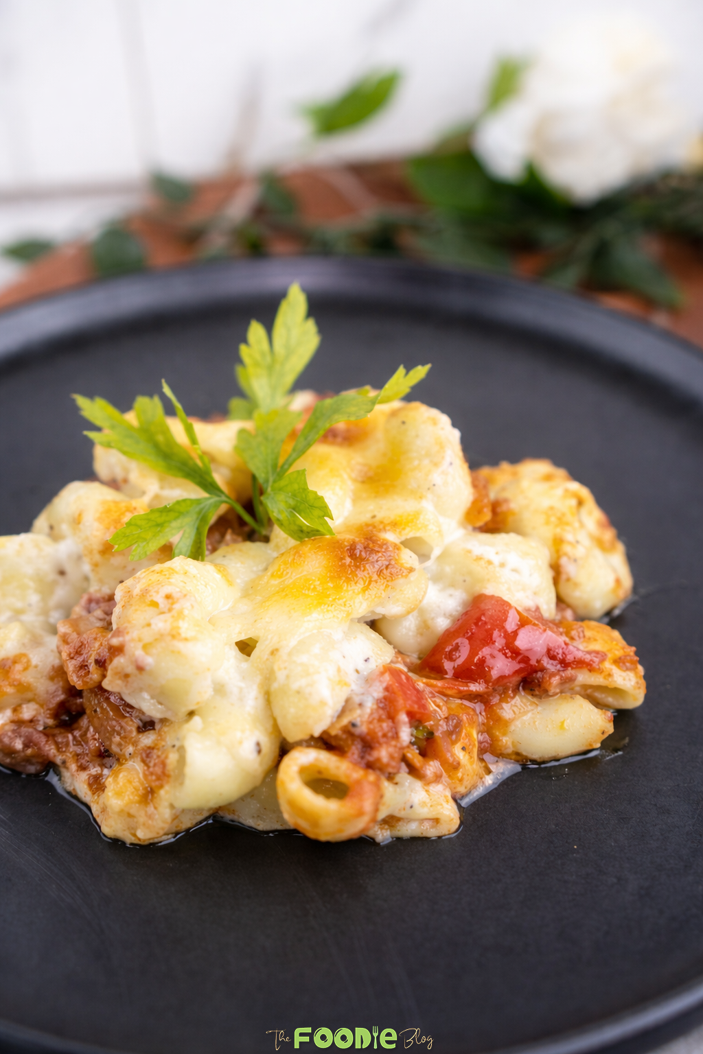 Close-up of cheese meat pasta bake with ground beef, tomato sauce, pasta, and melted mozzarella cheese.