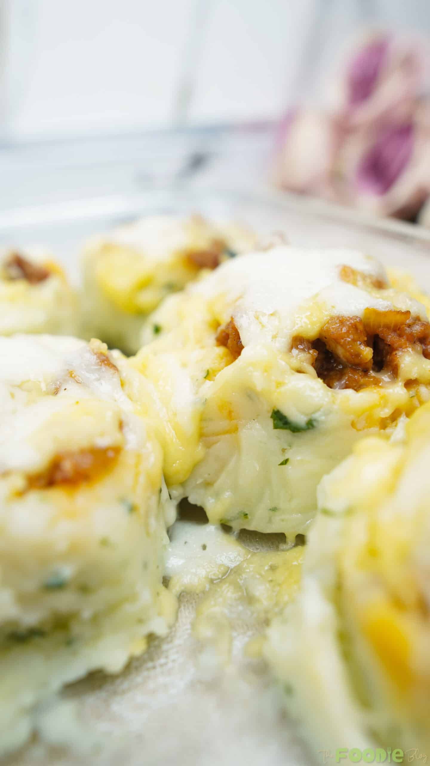 Close-up of melted cheese over mashed potato with beef filling in the center