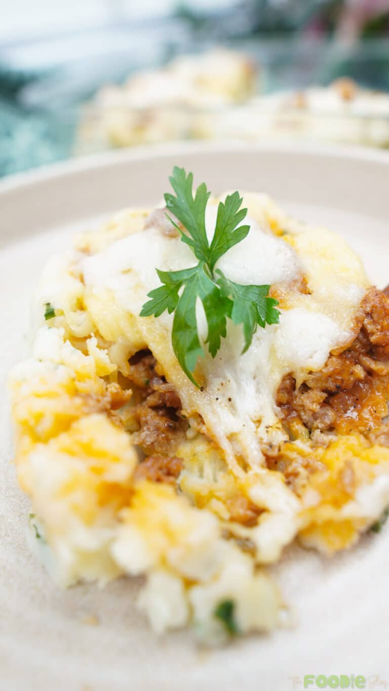 Cheesy potato ball filled with beef and stretchy melted cheese on a plate