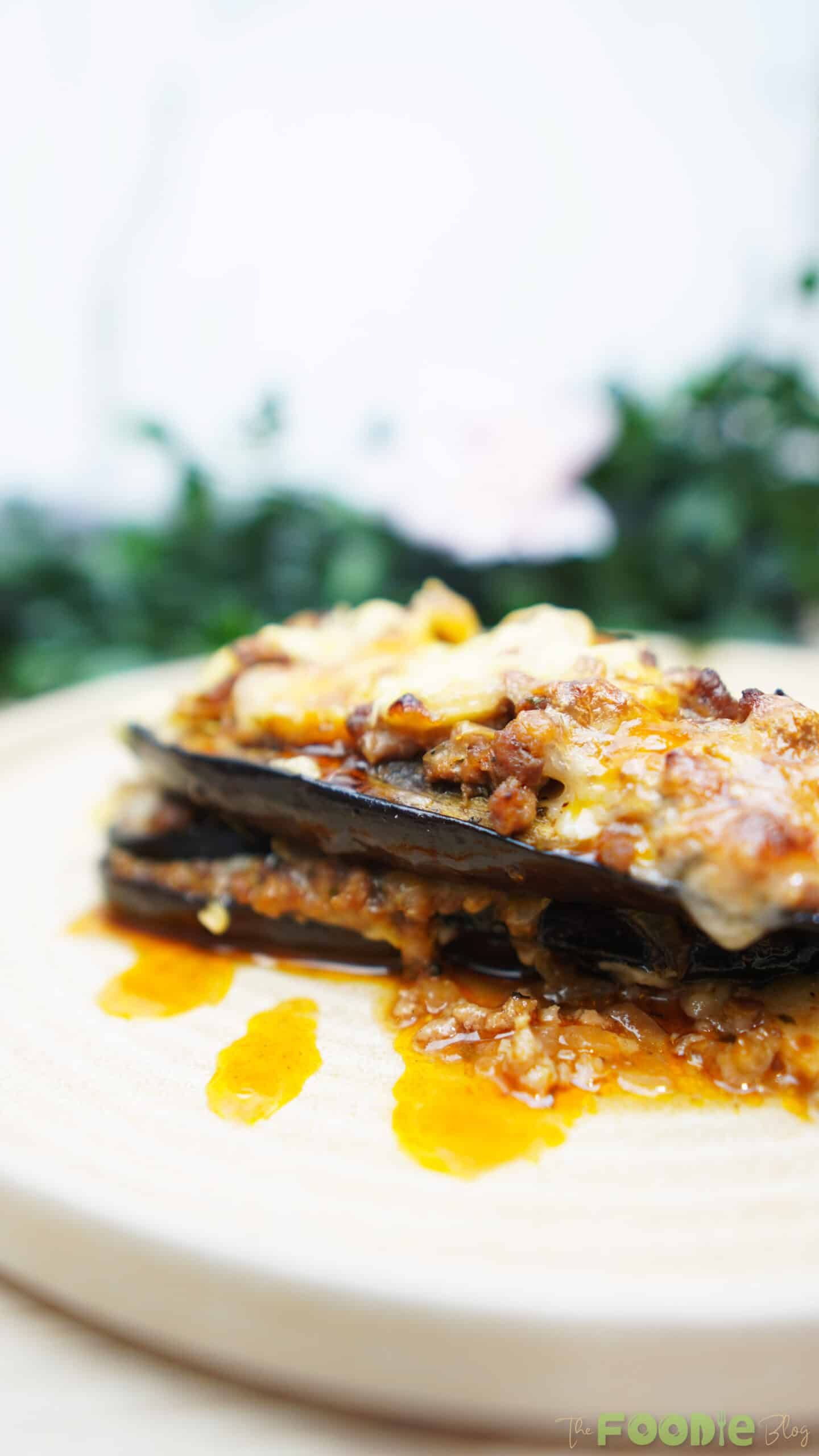 Side view of Cheesy Beef-Stuffed Eggplant Boats showing layers of eggplant, beef, and cheese