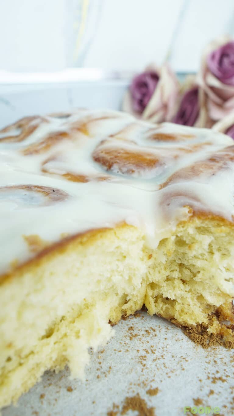 Close-up of cinnamon rolls with cream cheese icing showing a fluffy, tender interior