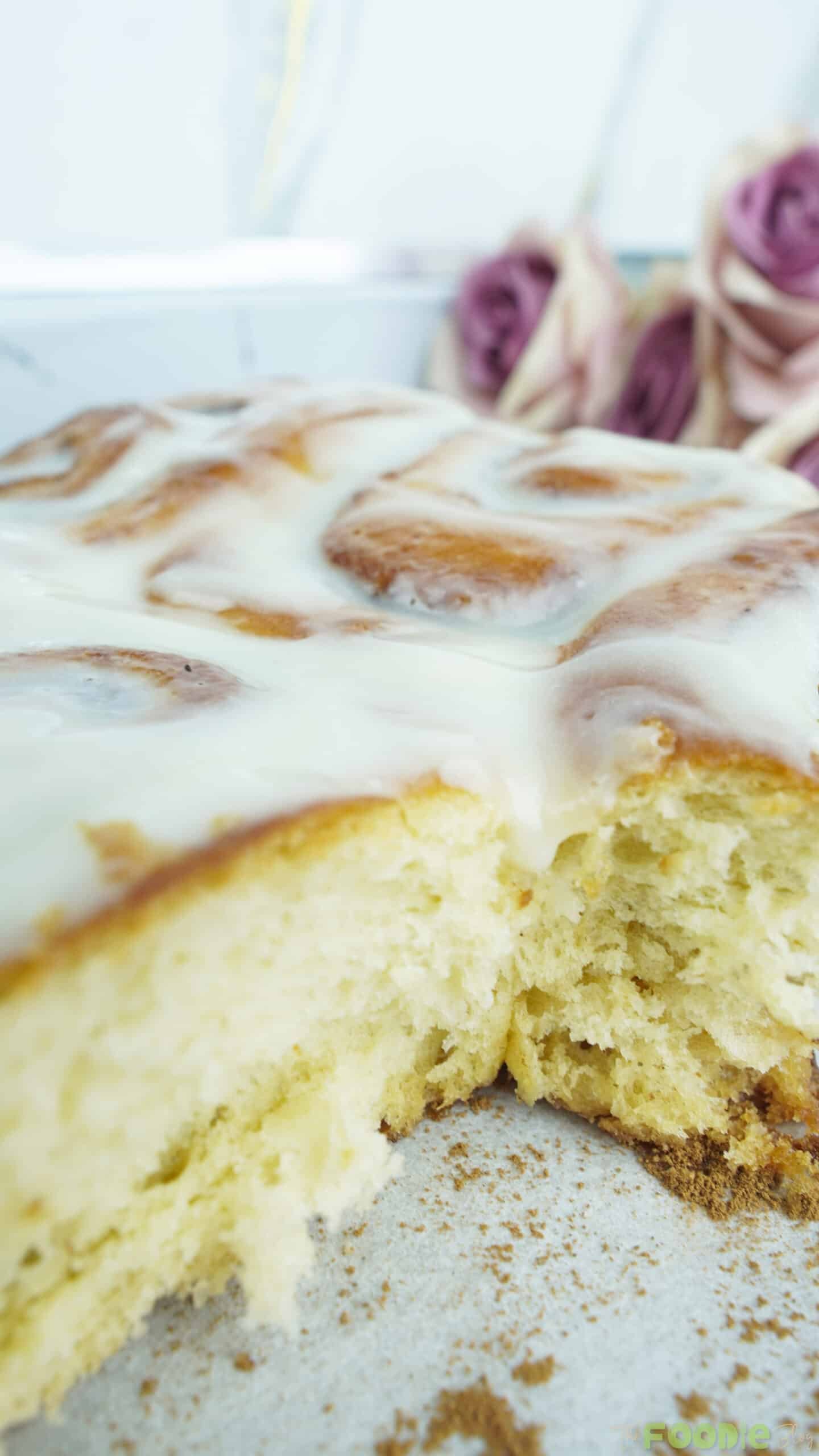 Close-up of cinnamon rolls with cream cheese icing showing a fluffy, tender interior