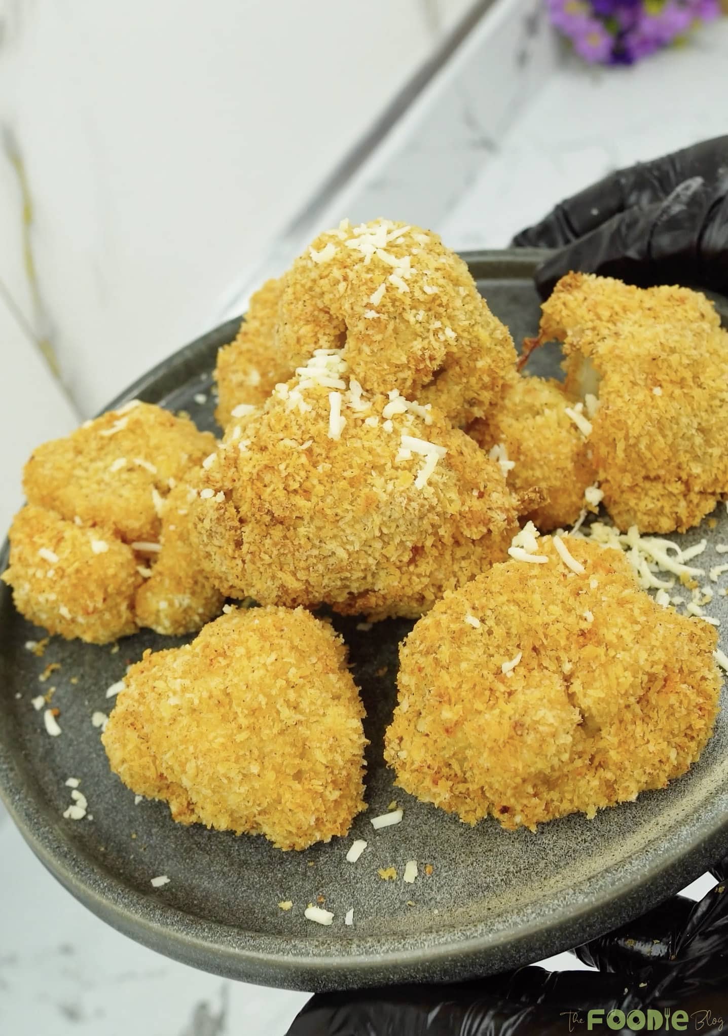 Close-up of golden crunchy cauliflower bites with a breadcrumb coating