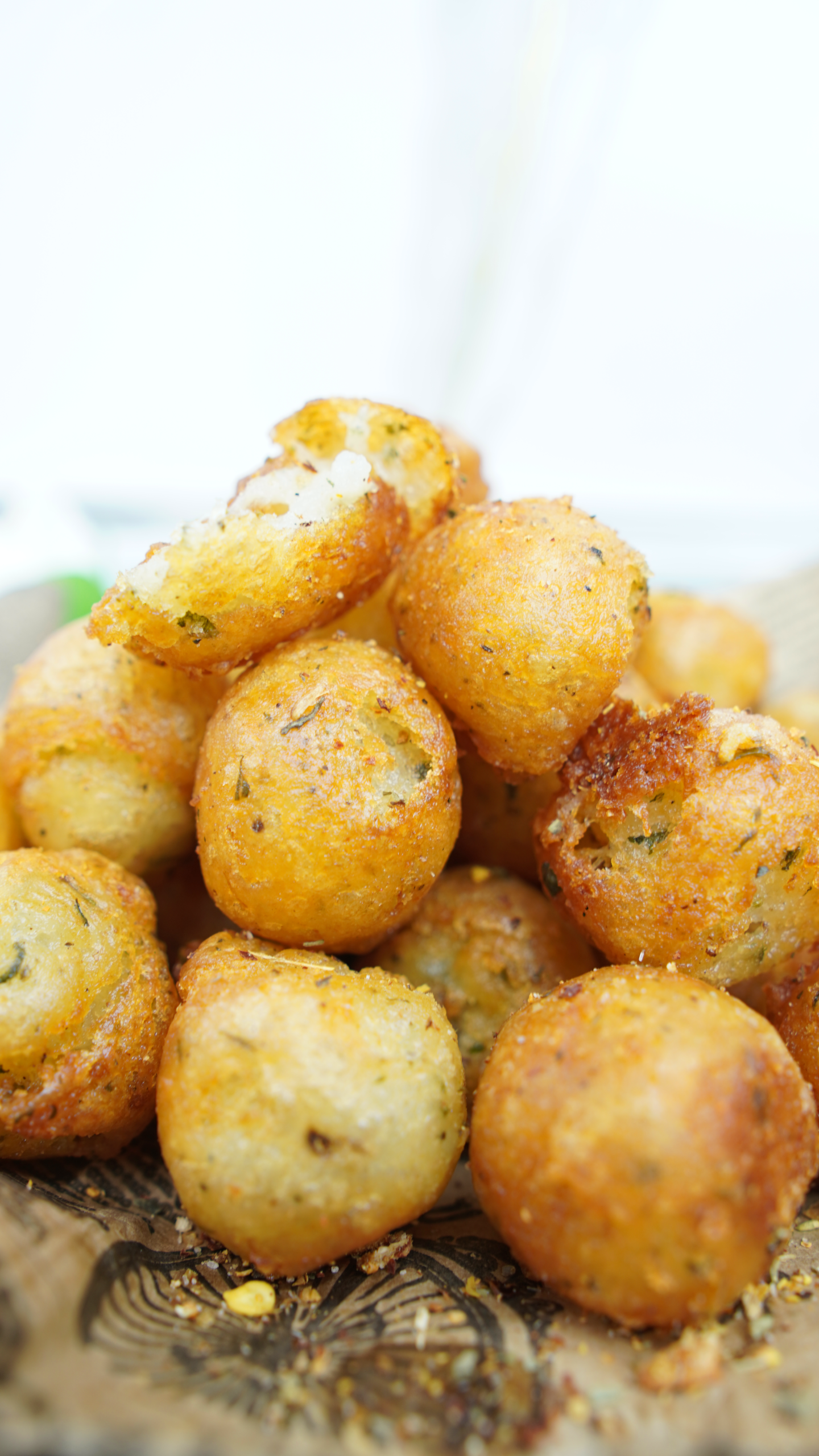Close-up of golden crispy potato balls stacked on a plate