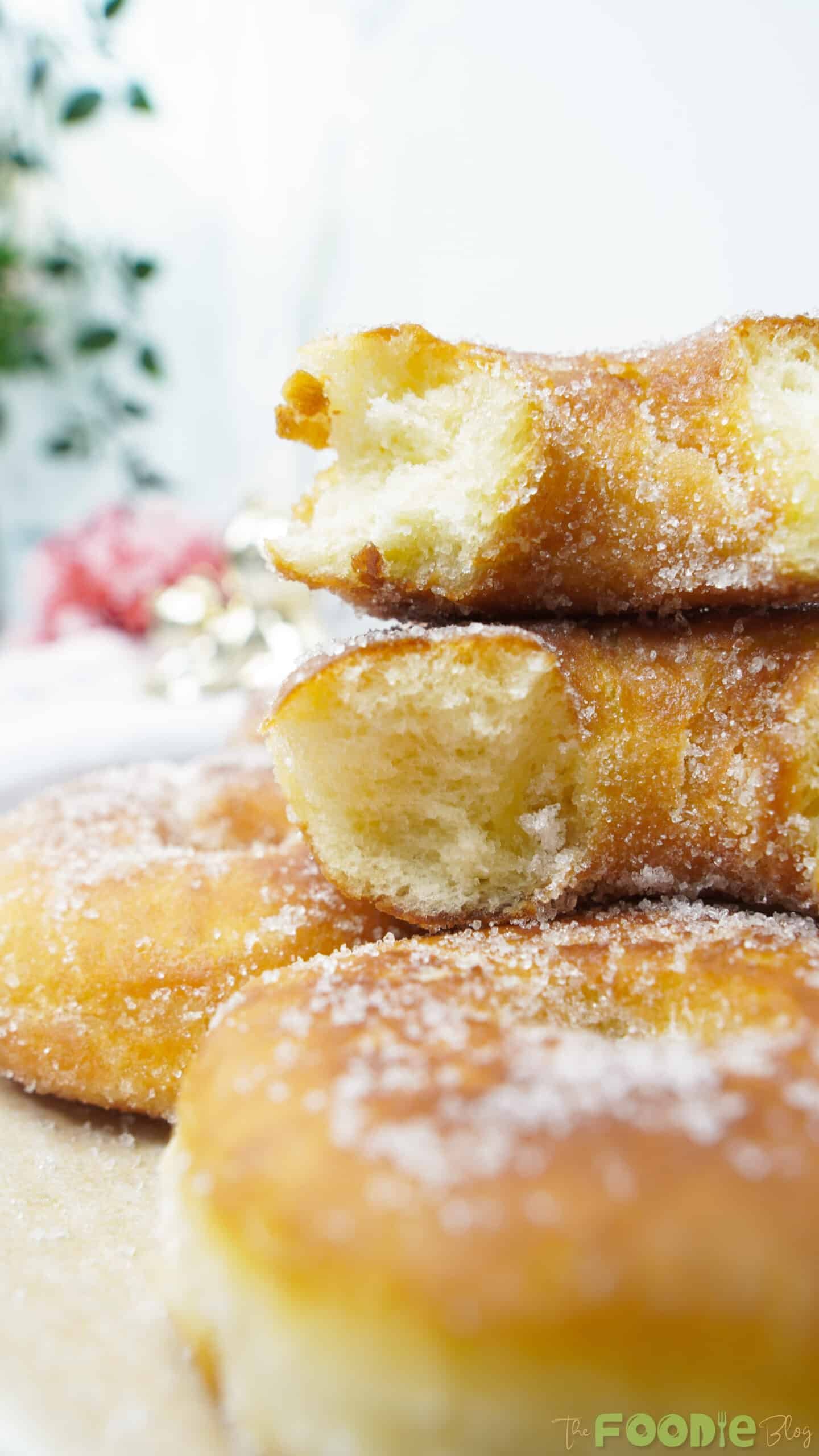 Bitten sugar-coated donut showing a soft, fluffy interior crumb