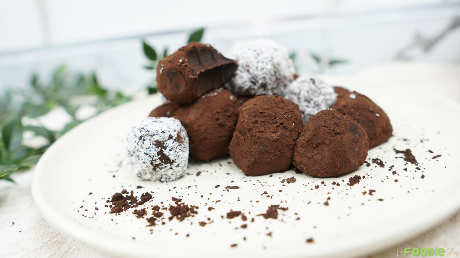 Top-down view of cocoa and coconut chocolate truffles on a plate