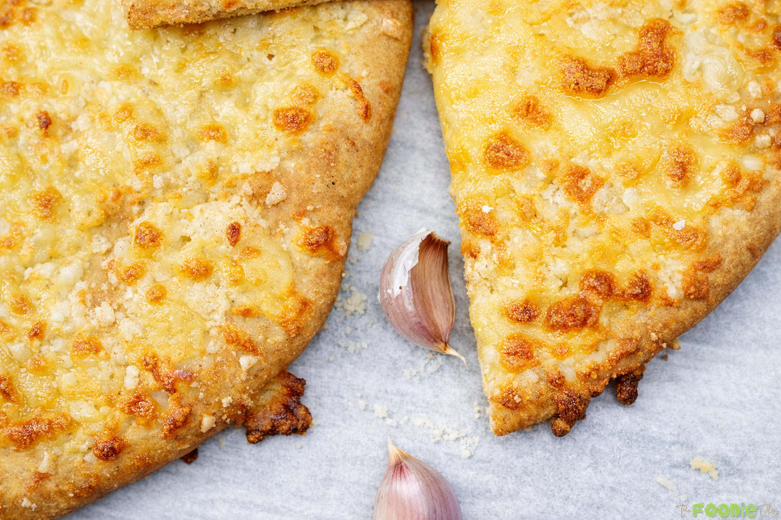 Close-up of a slice of garlic cheese bread with stretchy melted mozzarella cheese pull