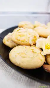 Close-up of Greek Cretan biscuits topped with almond flakes on a black plate