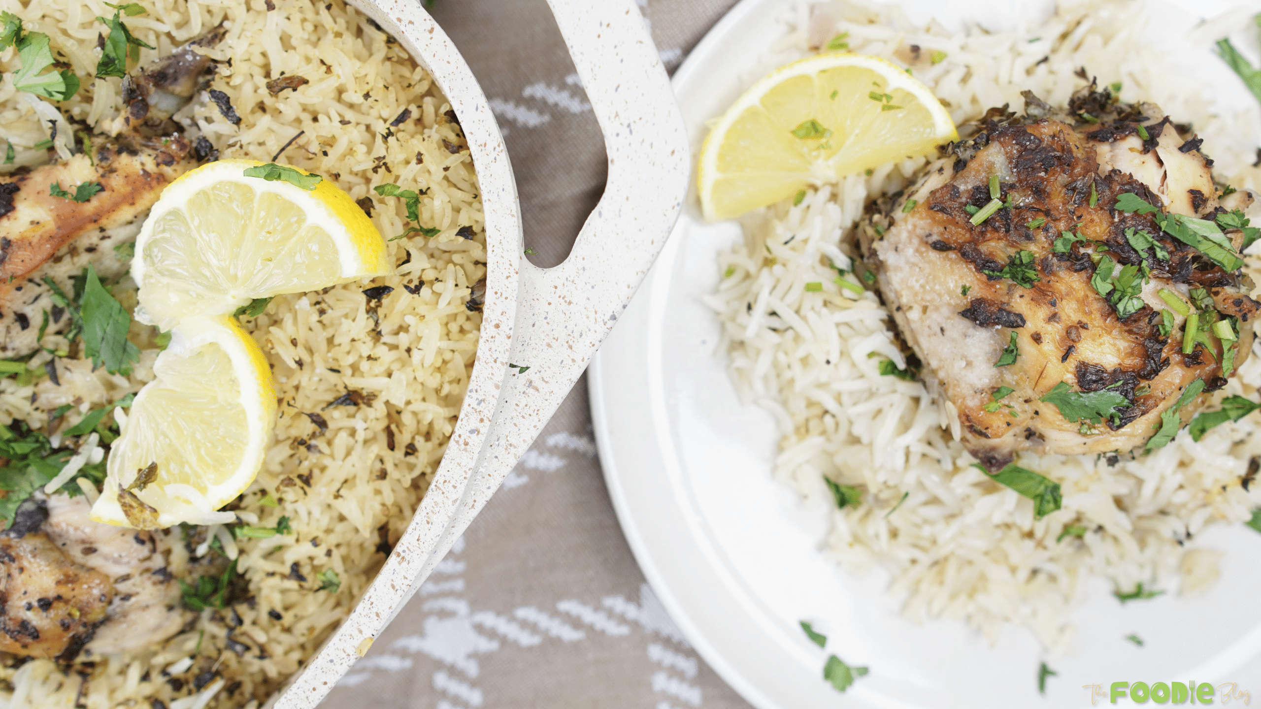 One pot chicken and lemon rice served with a lemon wedge and chopped parsley