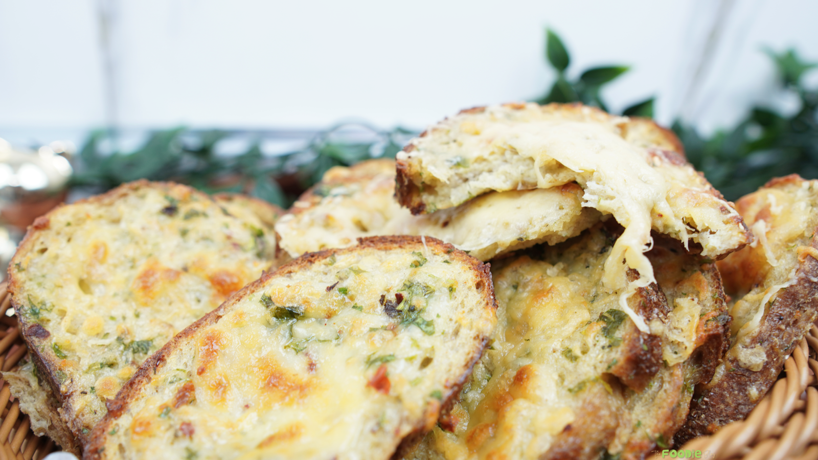 Cheesy oven baked egg toast slices stacked with melted mozzarella and herbs