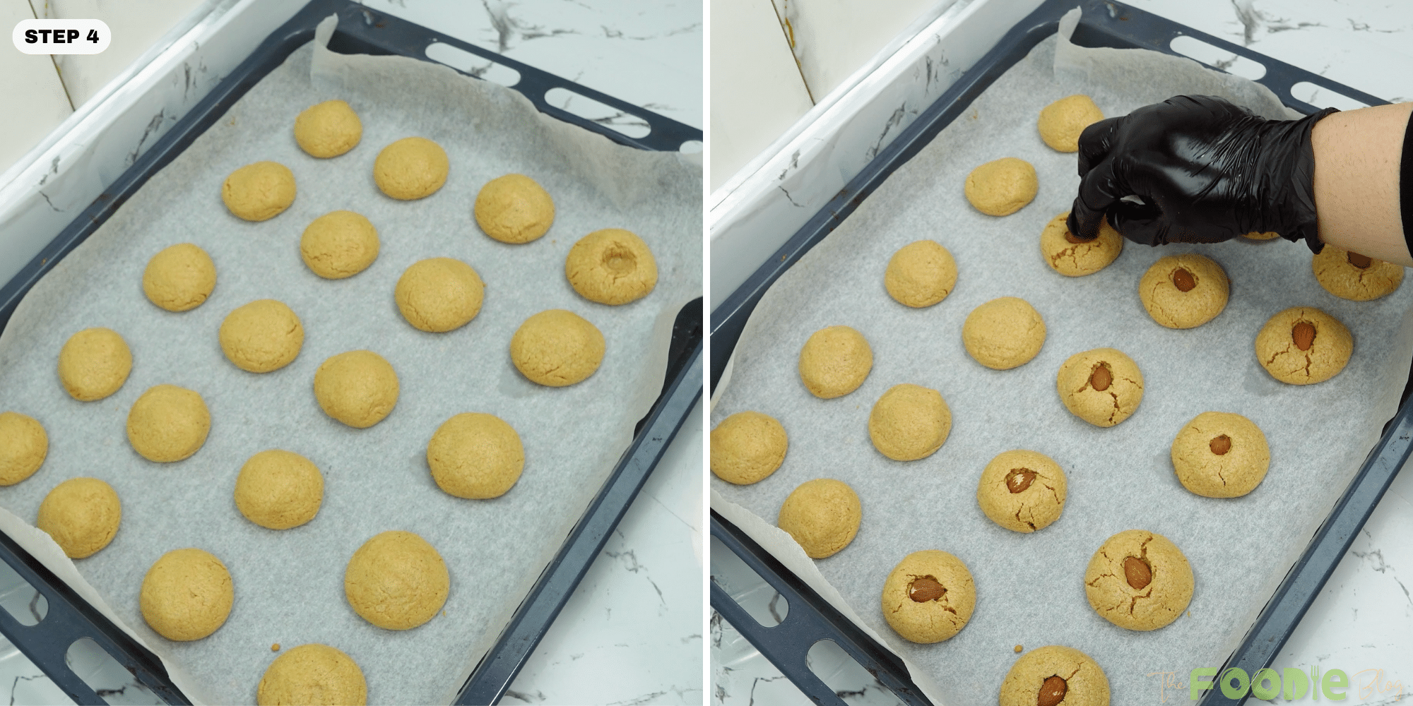 Hand pressing a whole almond into the center of warm baked cookies on a tray
