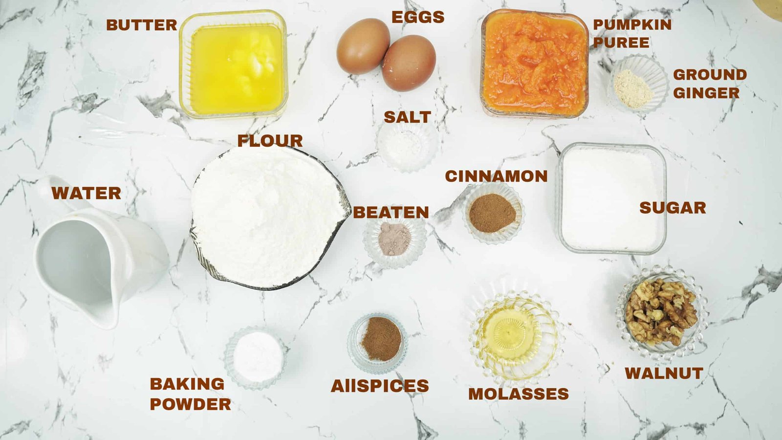 Measured ingredients for pumpkin bread including flour, pumpkin puree, eggs, sugar, spices, and walnuts