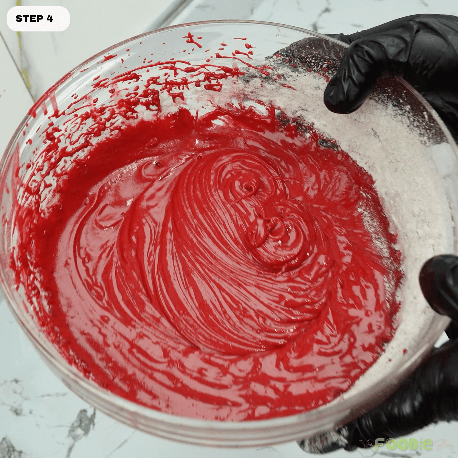 Bowl of red velvet batter ready to be covered and chilled before baking