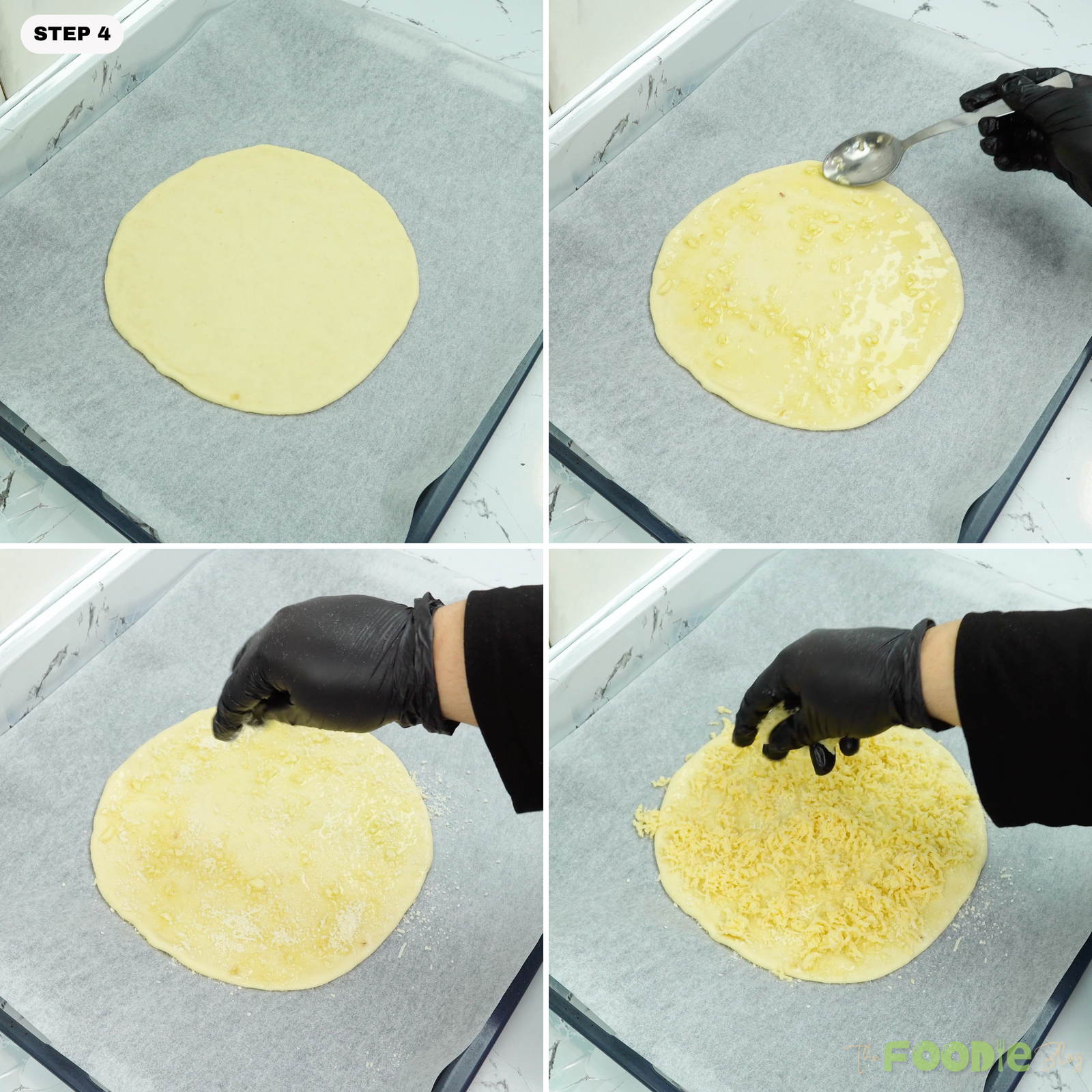 Garlic oil spread on dough and cheeses sprinkled on top on a parchment-lined pan