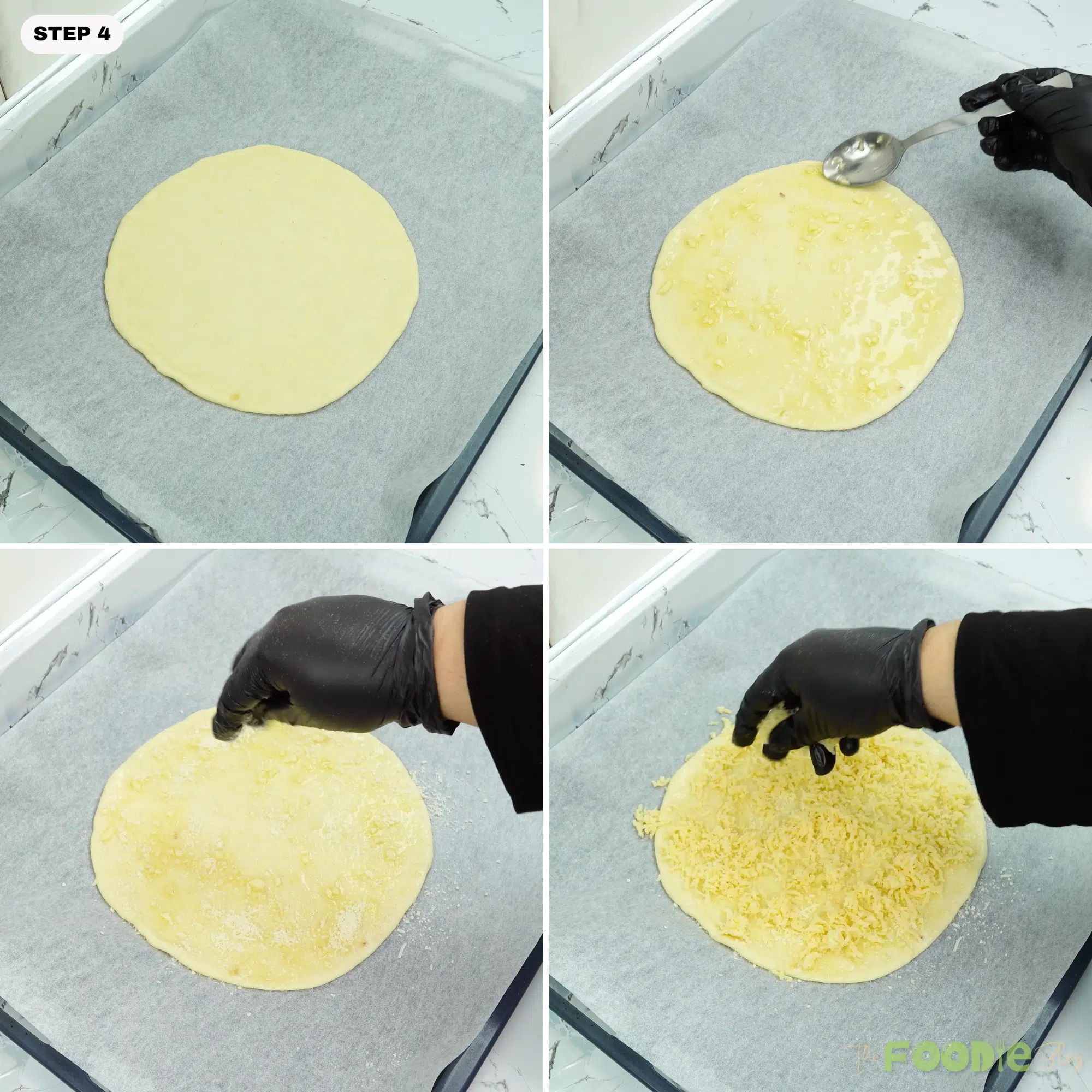 Garlic oil spread on dough and cheeses sprinkled on top on a parchment-lined pan