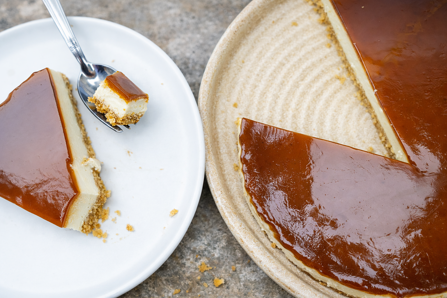 Top view of yogurt cheesecake with caramel coffee topping and a slice served on a white plate