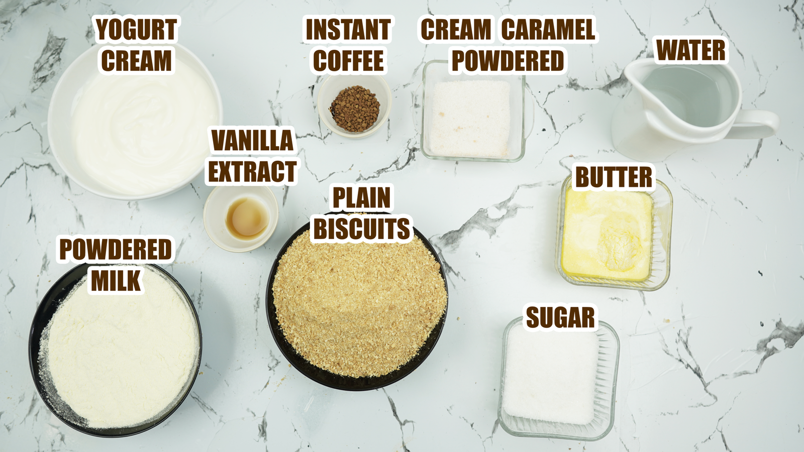 Ingredients labeled on a white marble surface for yogurt cheesecake and coffee caramel topping
