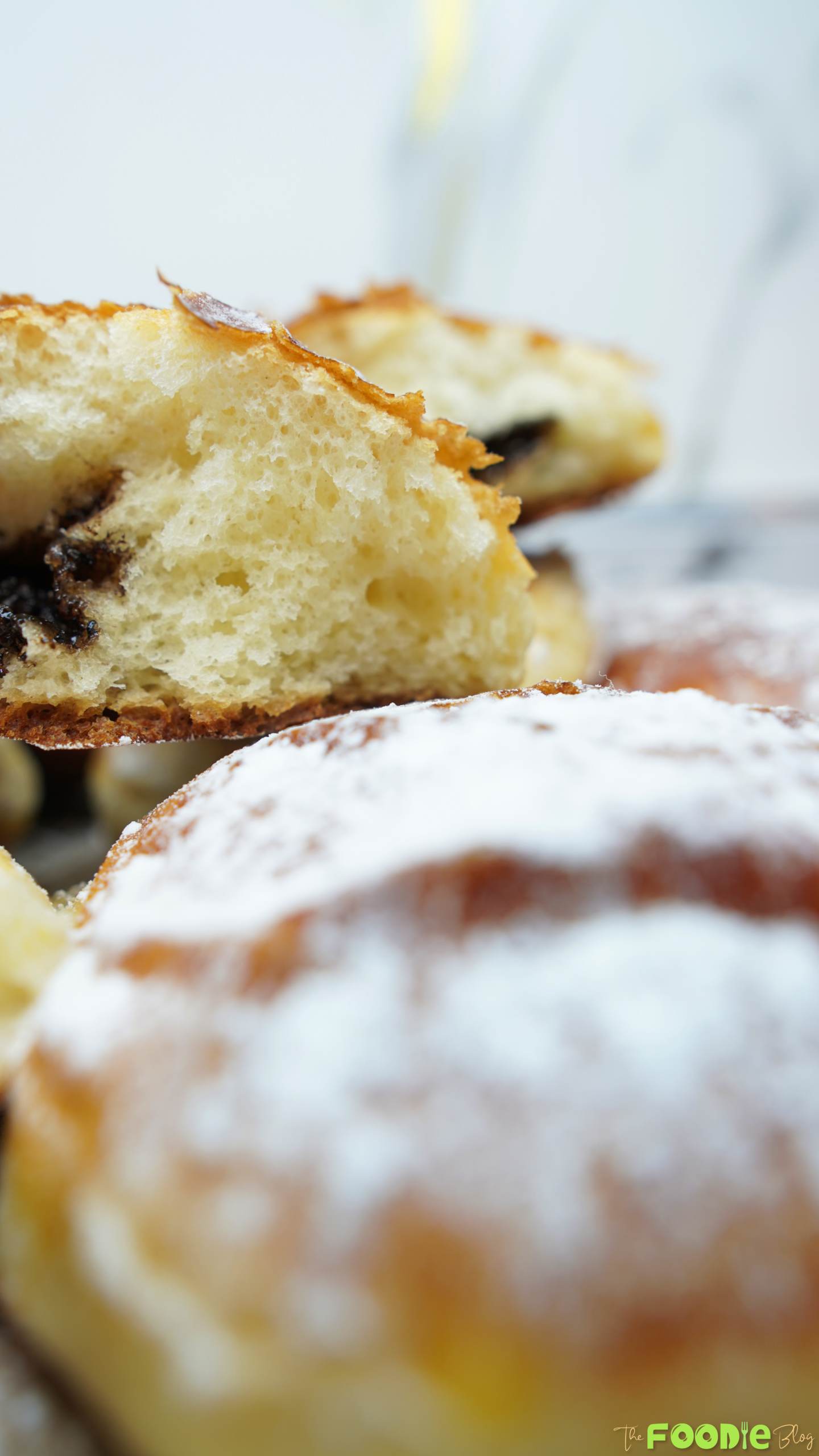 Close-up of a torn brioche showing fluffy crumb and a streak of chocolate filling