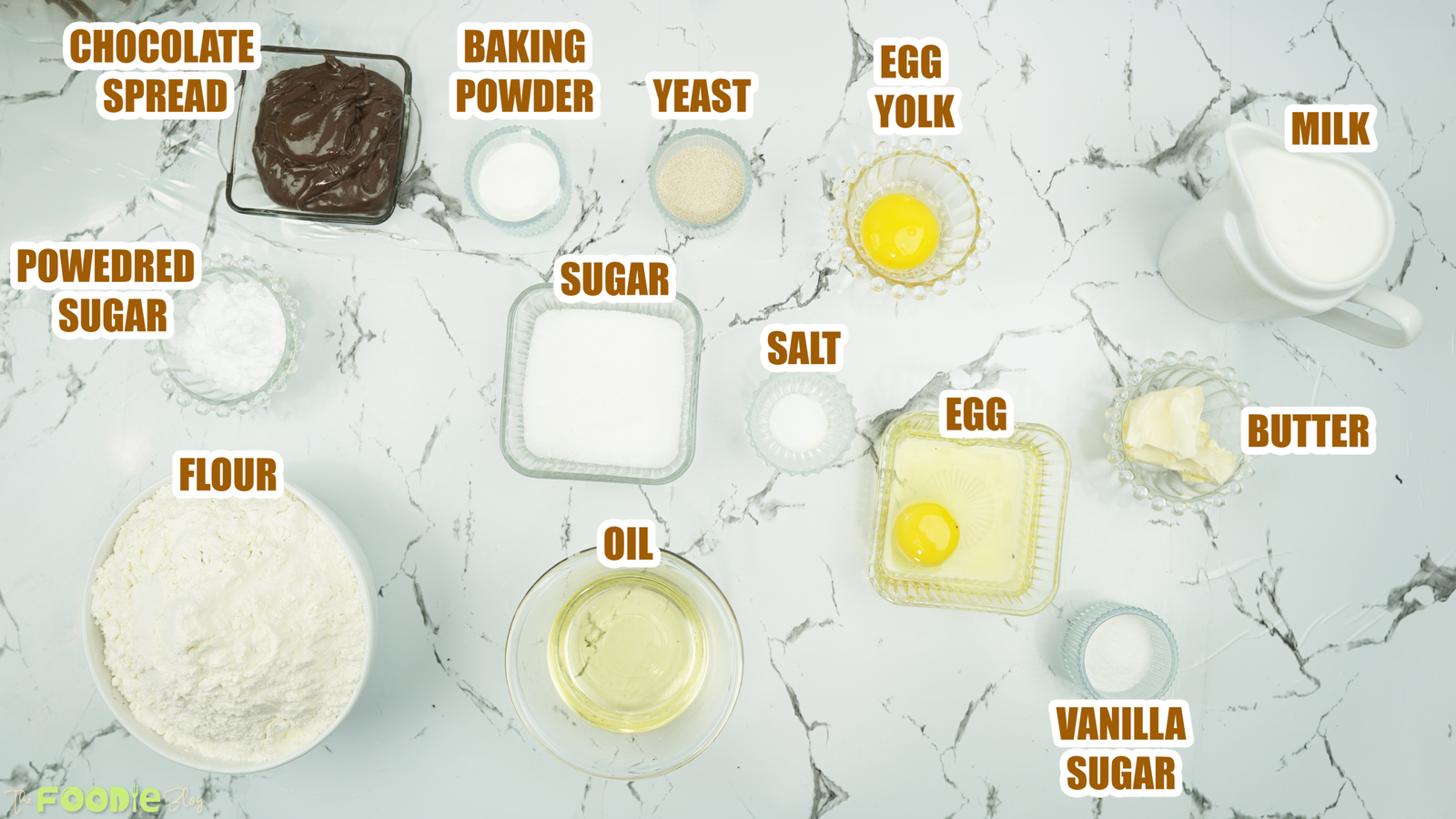 Measured ingredients for brioche dough and chocolate filling on a marble surface