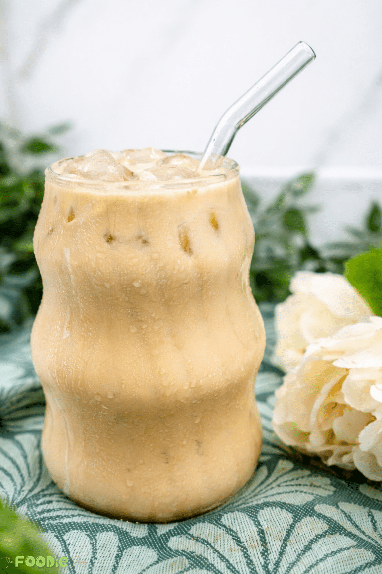 Chill coffee in a chilled glass with ice cubes and a glass straw.