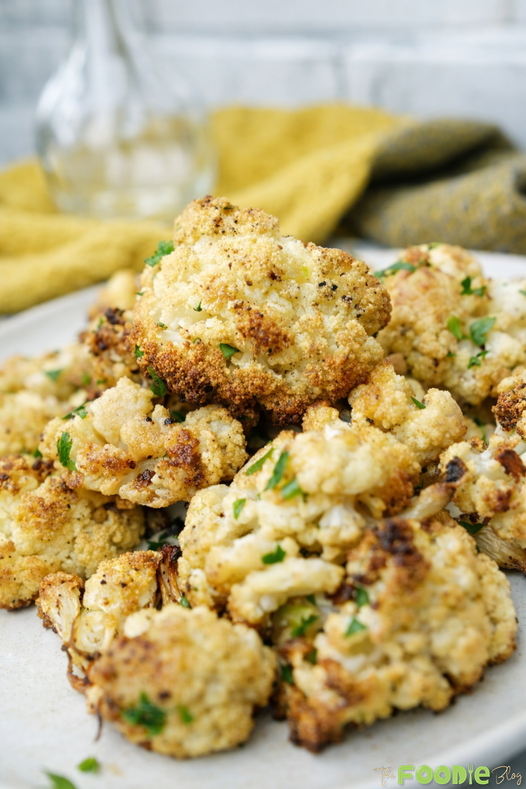 Close-up of crispy roasted cauliflower florets with parsley and garlic
