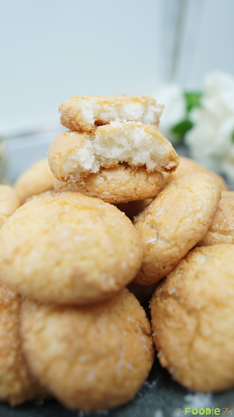 Close-up of a coconut macaroon broken open to show the chewy inside